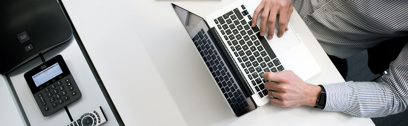 Corporate FAQ Man Working on Laptop